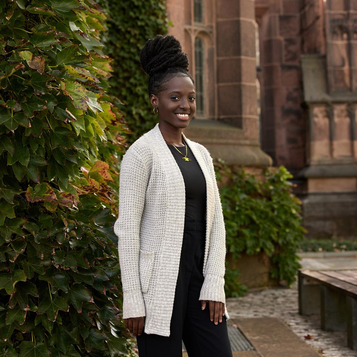 Jhonnelle Moore, smiling in front of East Pyne Hall.