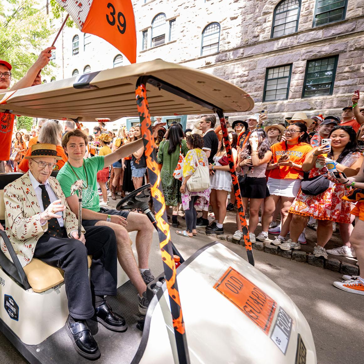 Don Fletcher in a golf cart cheered by Princetonians on the P-rade