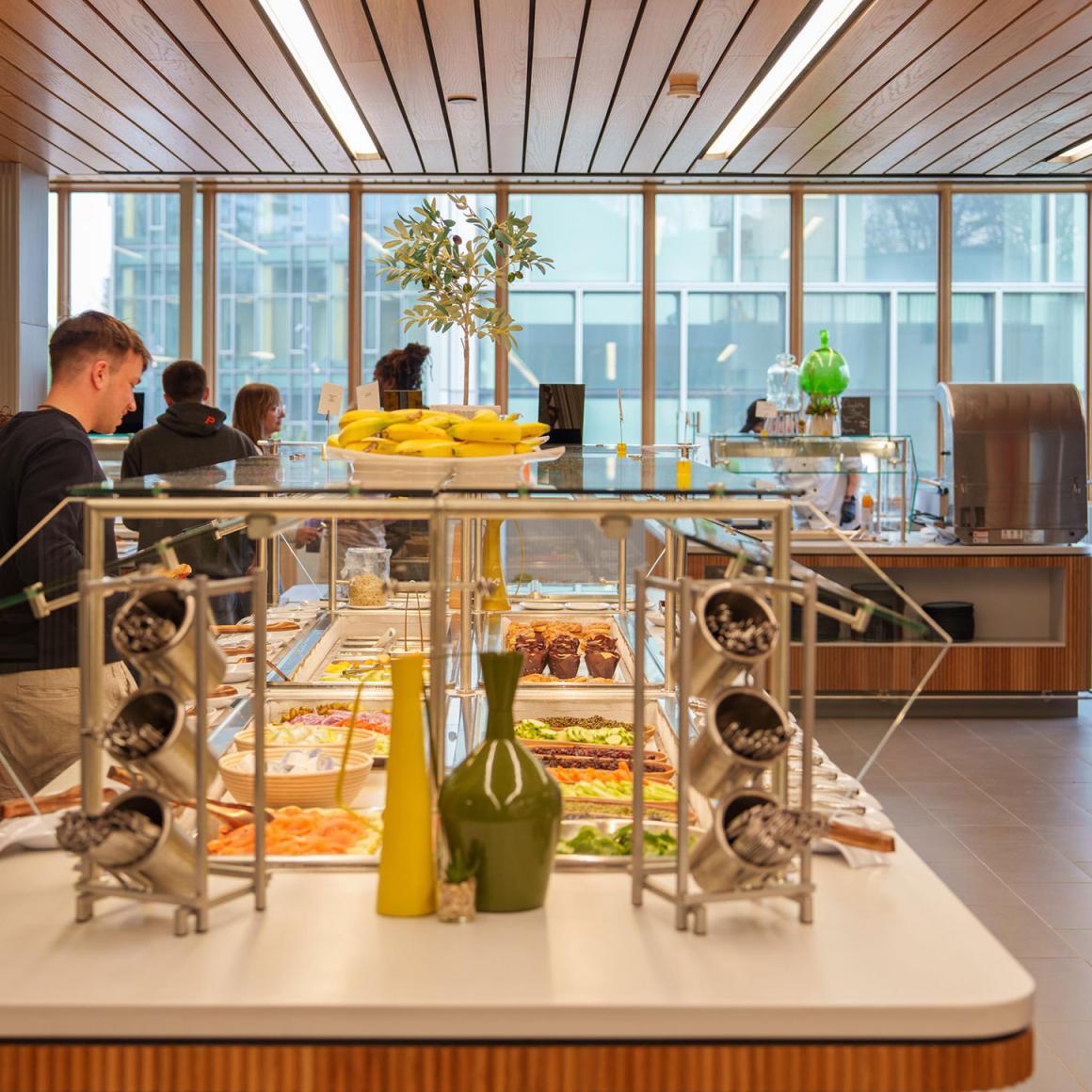 Students help themselves to dinner in the servery