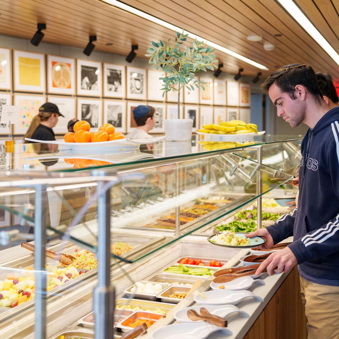 A student serves himself from a salad bar