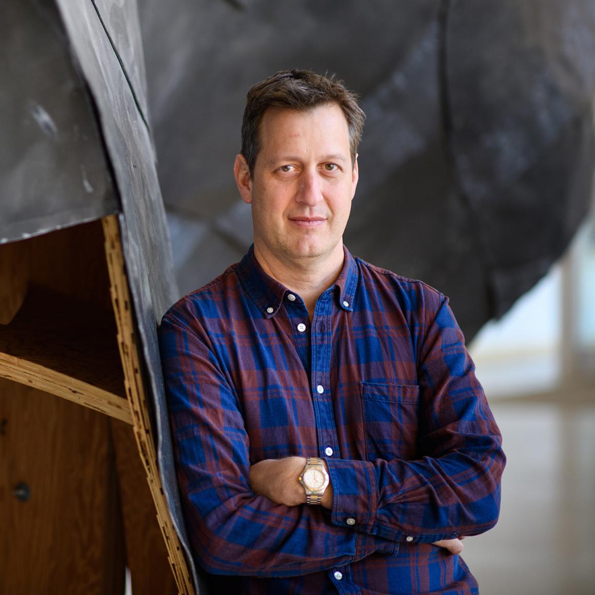 Jonathan Levine, with his arms crossed.