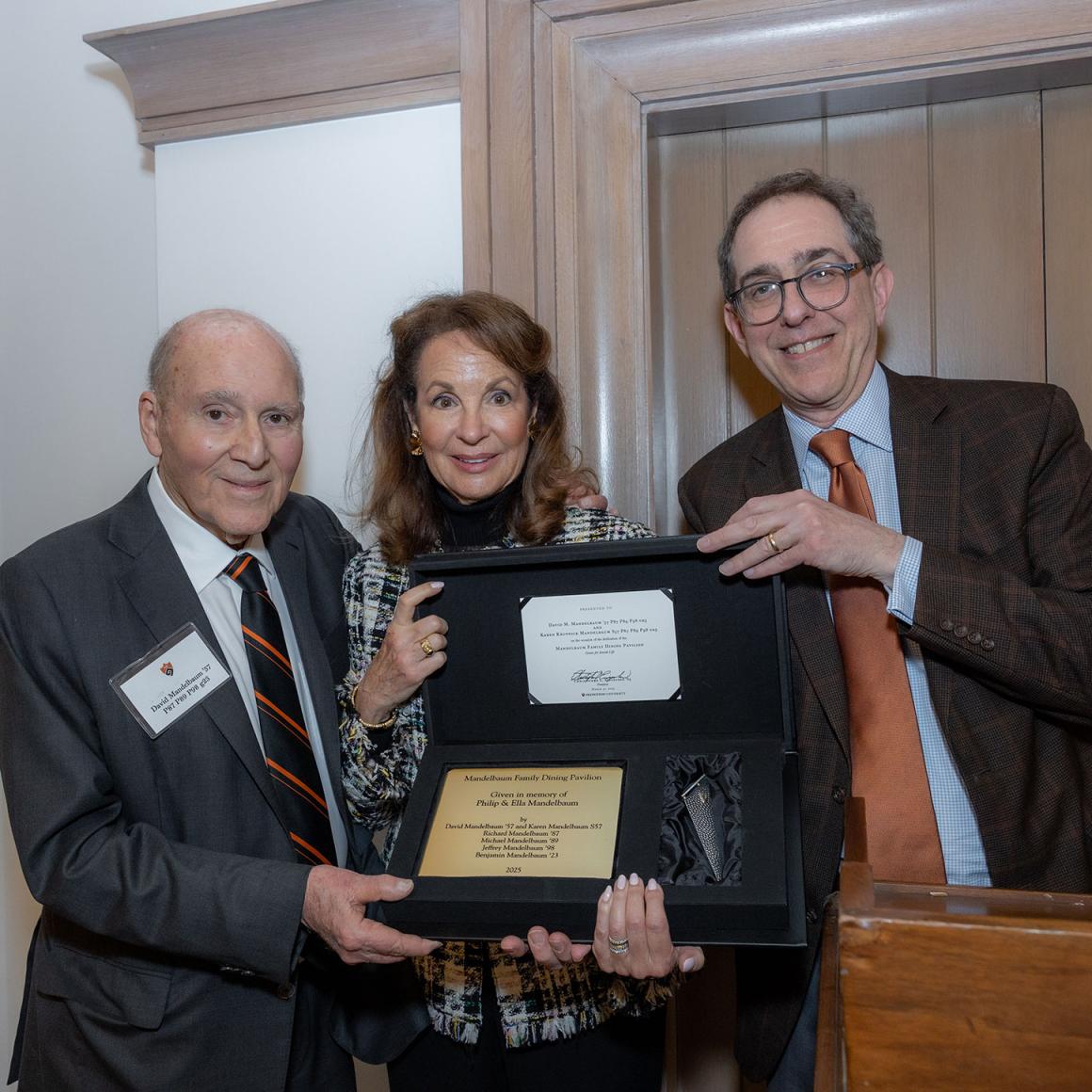 President Eisgruber with David and Karen Mandelbaum and a dedicatory gift