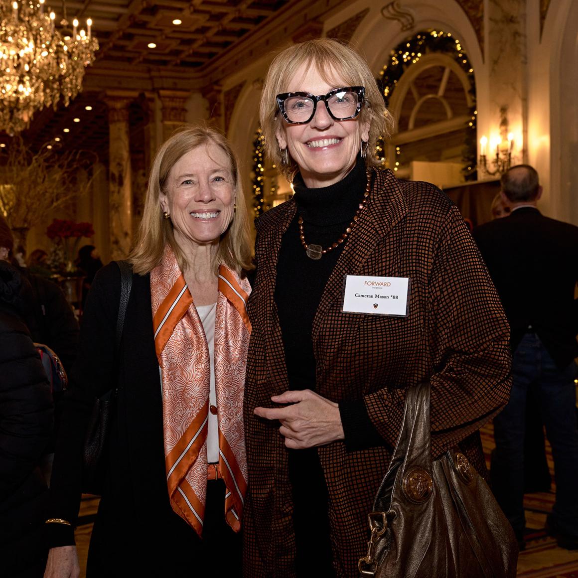 Two alumna, posing in their Princeton orange. 