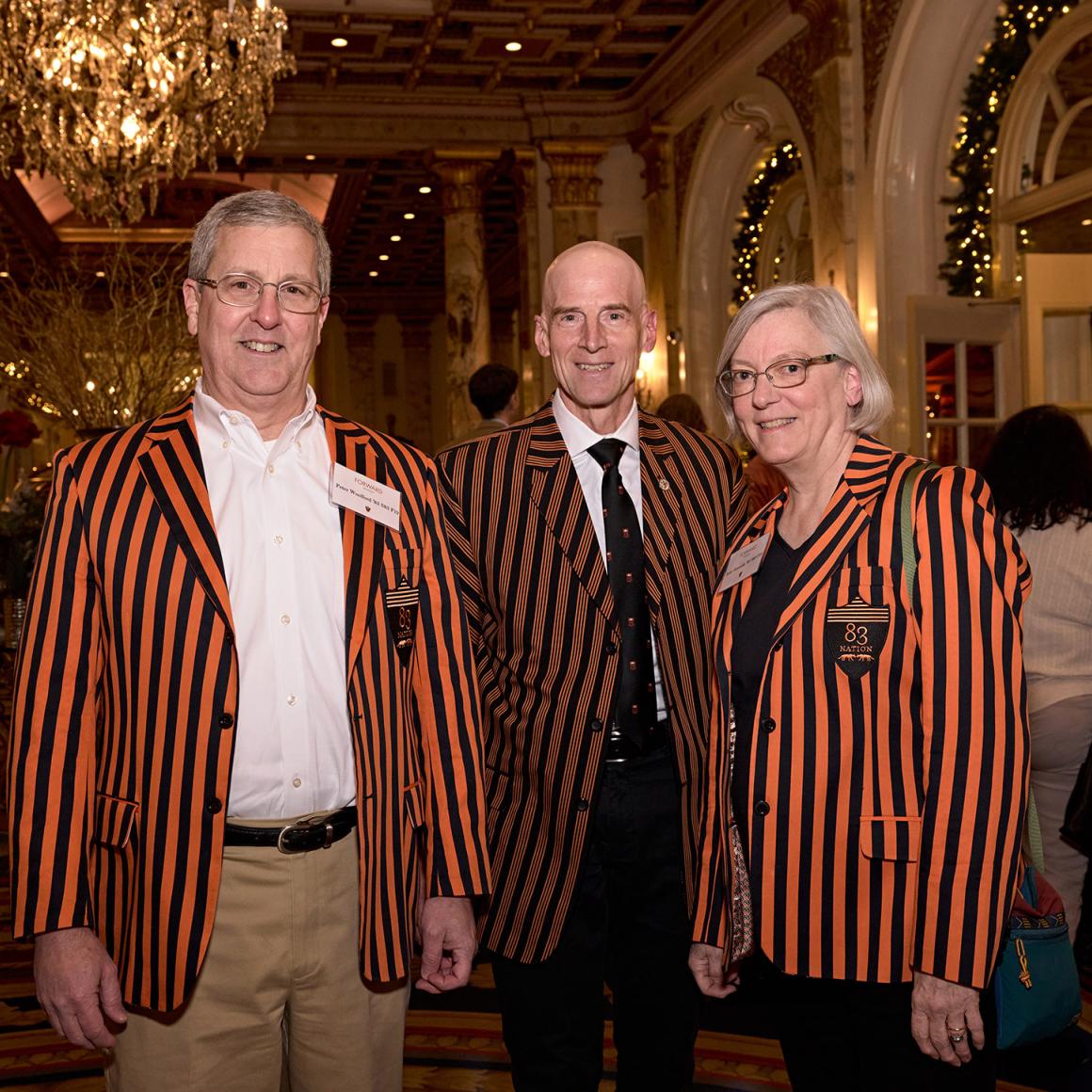 Three alumni, dressed in striped Princeton class jackets.