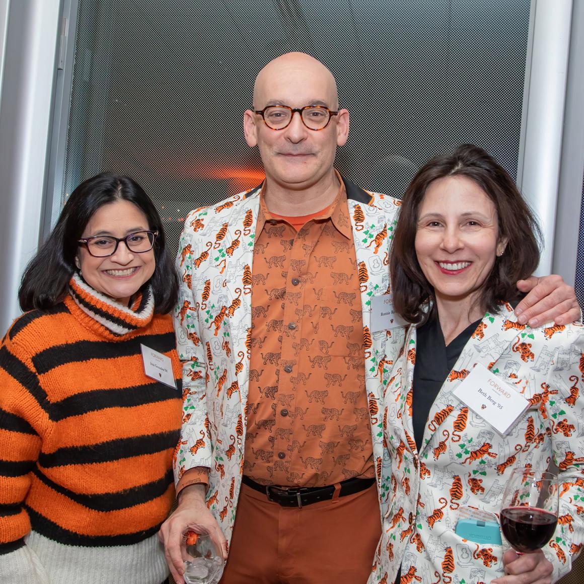 Thee Princeton alumni dressed in fashionable orange. 