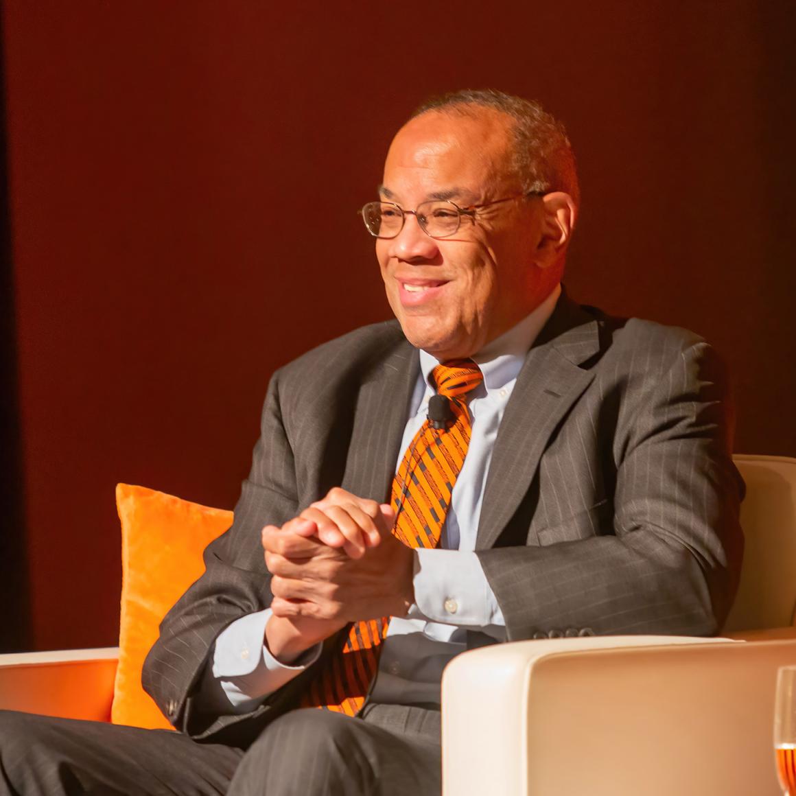 John Rogeers grins from the stage.