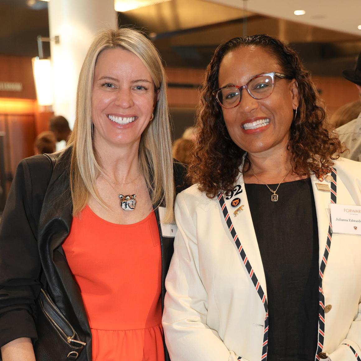 Two alumna wearing Princeton orange