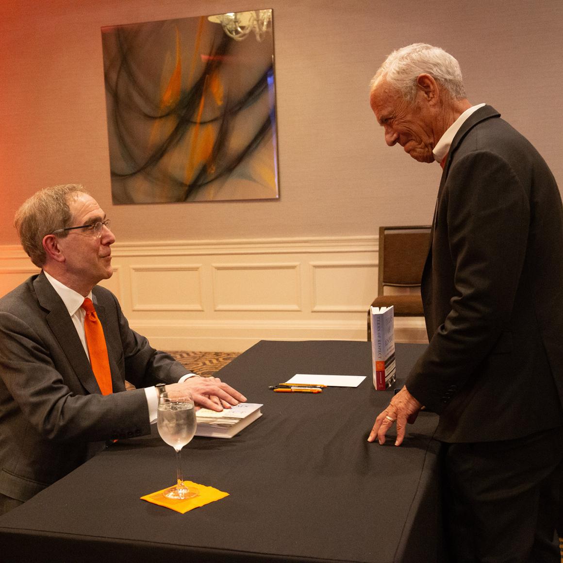 President Eisgruber signs a copy of his book for an alumnus