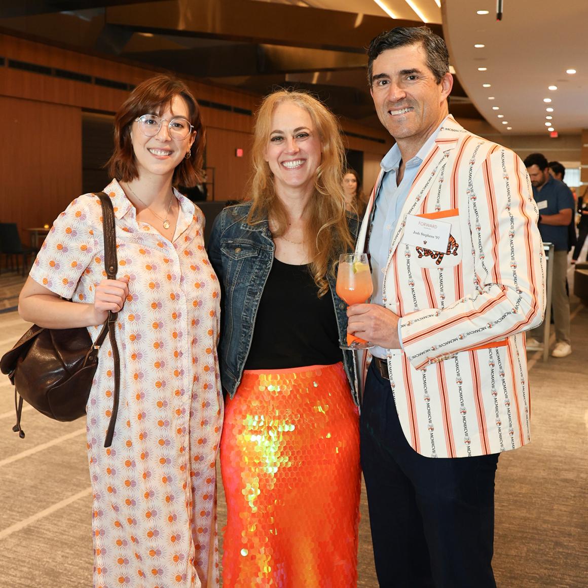 Three alumni wearing Princeton orange