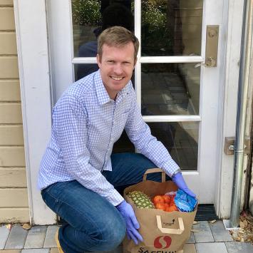 Brian Jaffee '06 holding basket of groceries