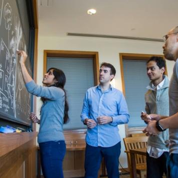 Graduate students at chalk board