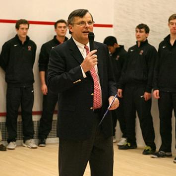 Bob Callahan speaks on a microphone prior to a match 