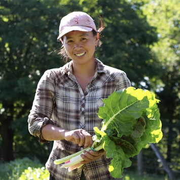 Iming Lin '03 holding fresh produce