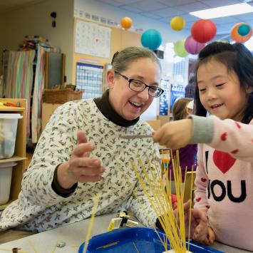 Sharon Carver '82 interacting with a preschooler