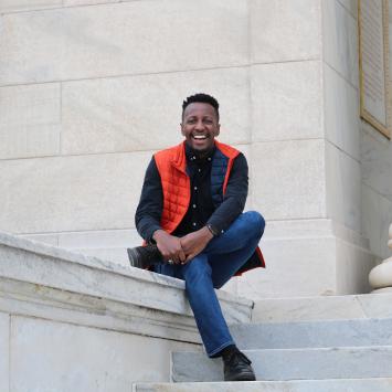 Brandon McGhee sitting on campus.