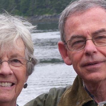 Myles Cohen and his wife, pictured outdoors near a river