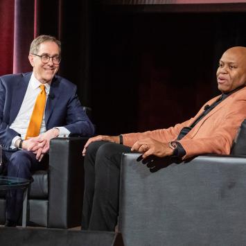 President Eisgruber smiling at Craig Robinson during a Venture Forward event in Chicago