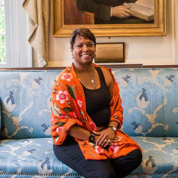 Monica Moore Thompson sitting on the blue sofa in Maclean House