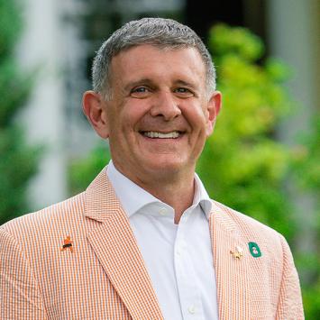 Ryan Ruskin, wearing his class jacket in front of Maclean House