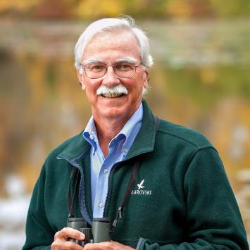 John Fitzpatrick, in nature, holding binoculars