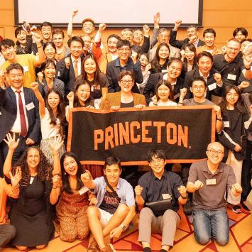Jen Rexford and alumni from Japan hold a Princeton banner