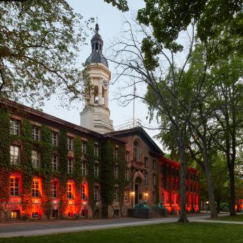 Nassau Hall, illuminated by orange lights