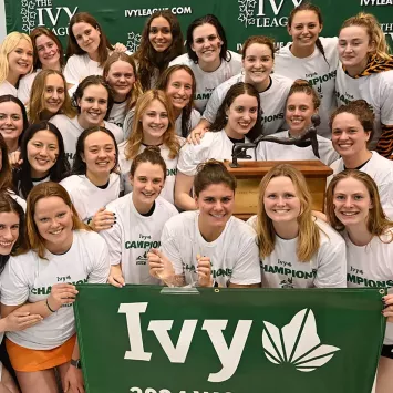 Members of the Princeton women's swimming and diving team celebrate their Ivy League title in 2024