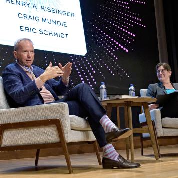 Eric Schmidt and Jen Rexford, seated on stage of McCosh 50
