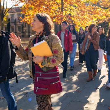 Students from the team-taught Humanities Sequence cross campus with course professors Esther “Starry” Schor (foreground) and Barbara Graziosi (in brown jacket).