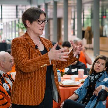 Provost Jennifer Rexford speaks to tables full of alumni