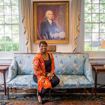 Monica Moore Thompson seated in front of James Madison portrait