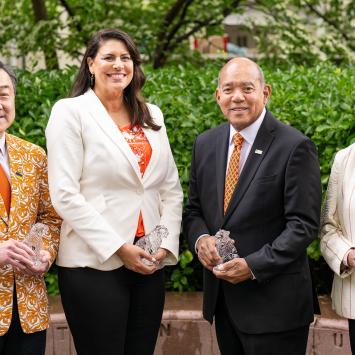 The four winners of the 2025 Award for Service to Princeton hold their crystal tigers