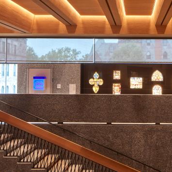 An interior of the Grand Stairs and oritnation gallery of the new Princeton University Art Museum, with campus showing through the glass