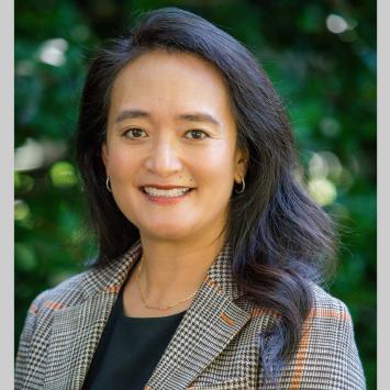 Portrait of April Chou with leafy green background