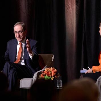 President Eisgruber gestures with his hands to make a point in his conversation on stage with Melissa Wu.