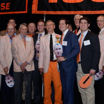 Chase Bryce, surrounded by alumni holding cut-outs of his face