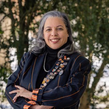 Patrice Jean, arms crossed, dressed in her orange-striped black Princeton blazer.