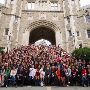 A group photo from the 2015 We Flourish conference with hundreds of Asian alumni on the steps of Blair Arch.