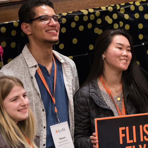 Students with "FLi is Fly" sign