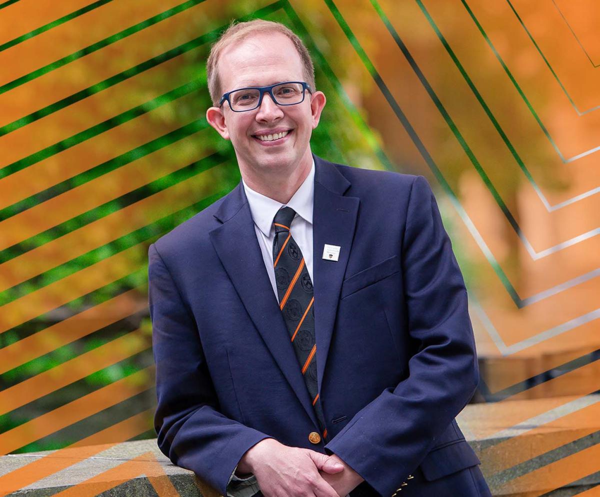 Andrew Houck, dressed in blazer and tie