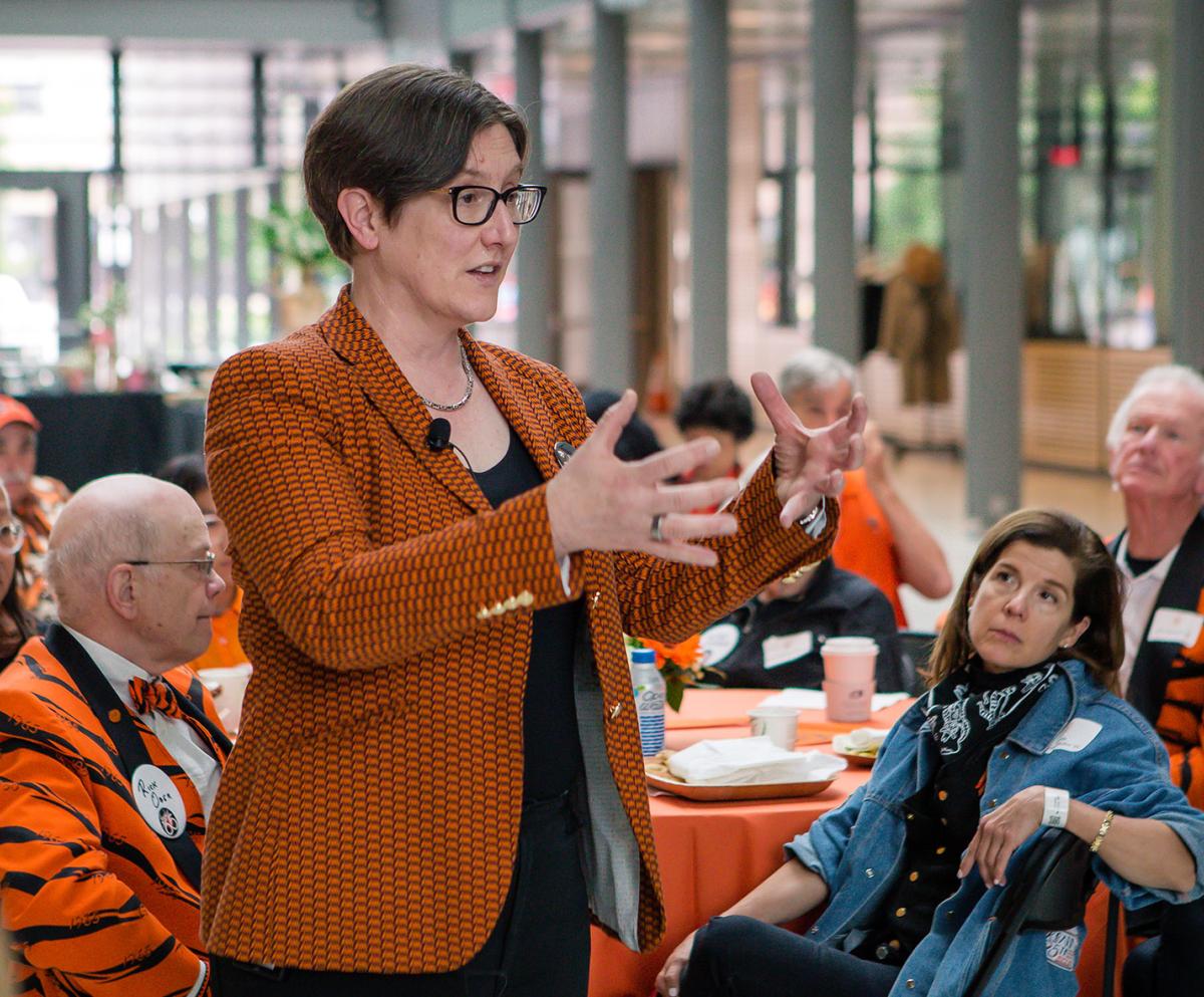 Provost Jennifer Rexford speaks to tables full of alumni
