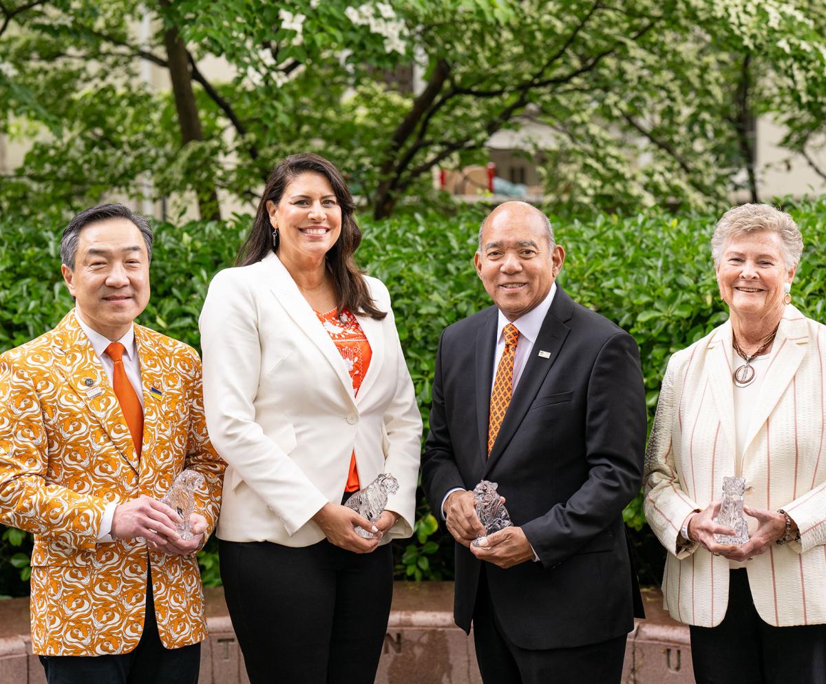 The four 2025 award winners with their crystal tigers