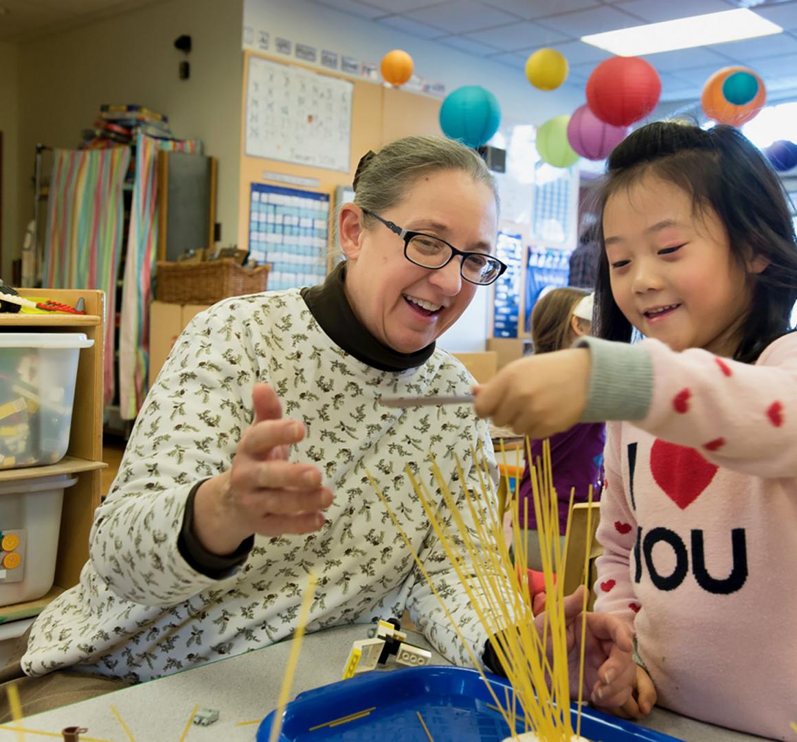 Sharon Carver '82 interacting with a preschooler