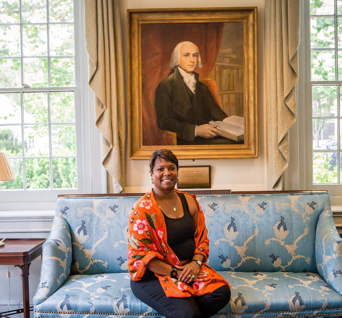 Monican Moore Thompson, seated in Maclean House, with a portrait of James Madison behind her