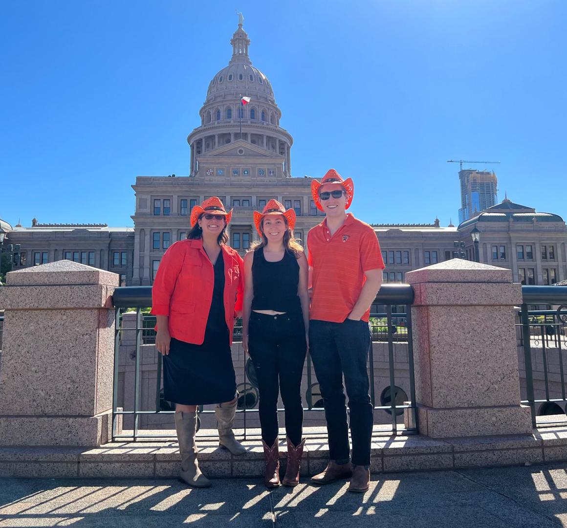 Marisa Goldenberg and two other members of the Princeton Club of Austin pose in front of the Texas capital building