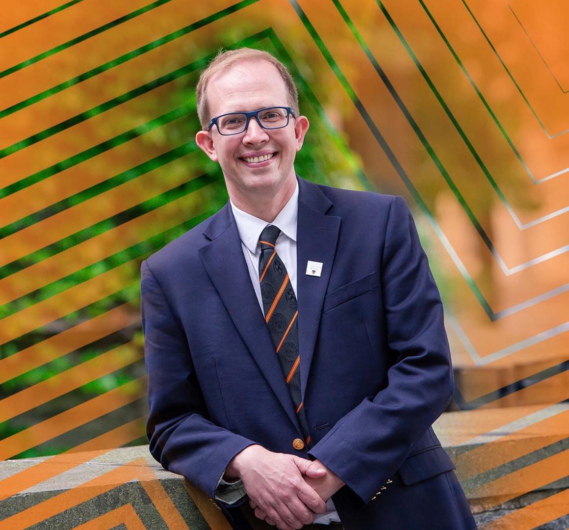 Andrew Houck, dressed in blazer and tie