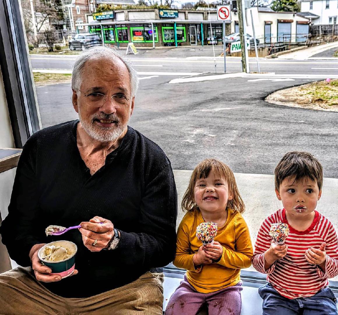 Doug Grover '74 and two grandchildren eat ice cream together