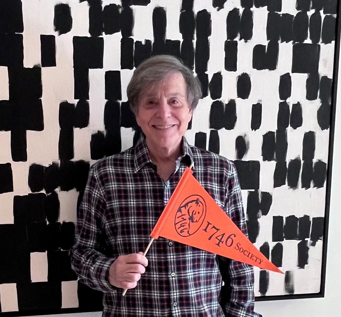 Headshot of Gary Forlini holding a 1746 Society pennant
