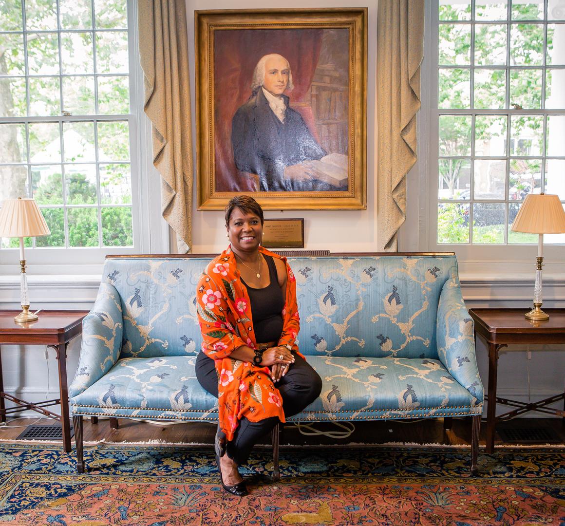 Monica Moore Thompson seated in front of James Madison portrait