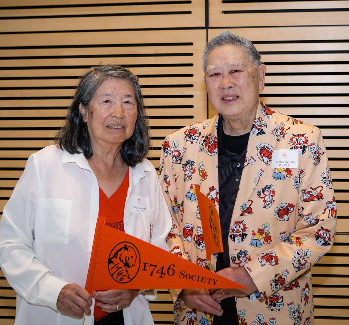 headshot of Kay and Leighton Chen with 1746 Society pennant